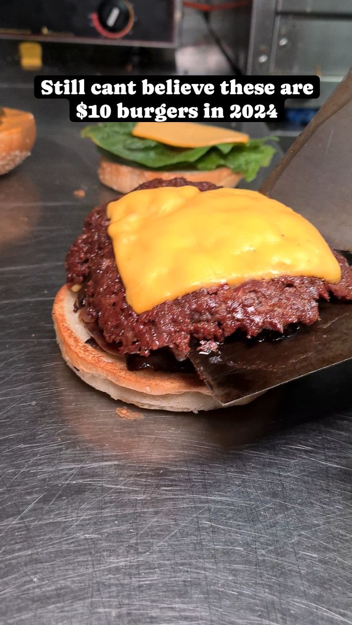 An affordable sneaky burger with cheese on it.